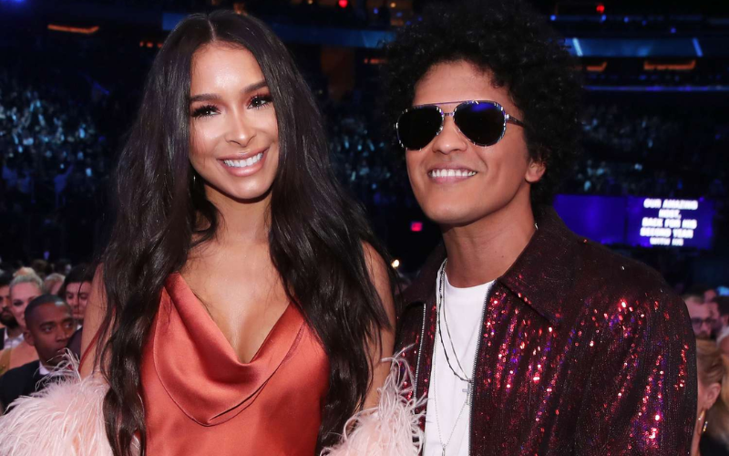 this image shows that Bruno Mars and Jessica Caban on the red carpet at the 2014 Grammys, looking glamorous and celebrating Bruno’s big win for Best Pop Vocal Album